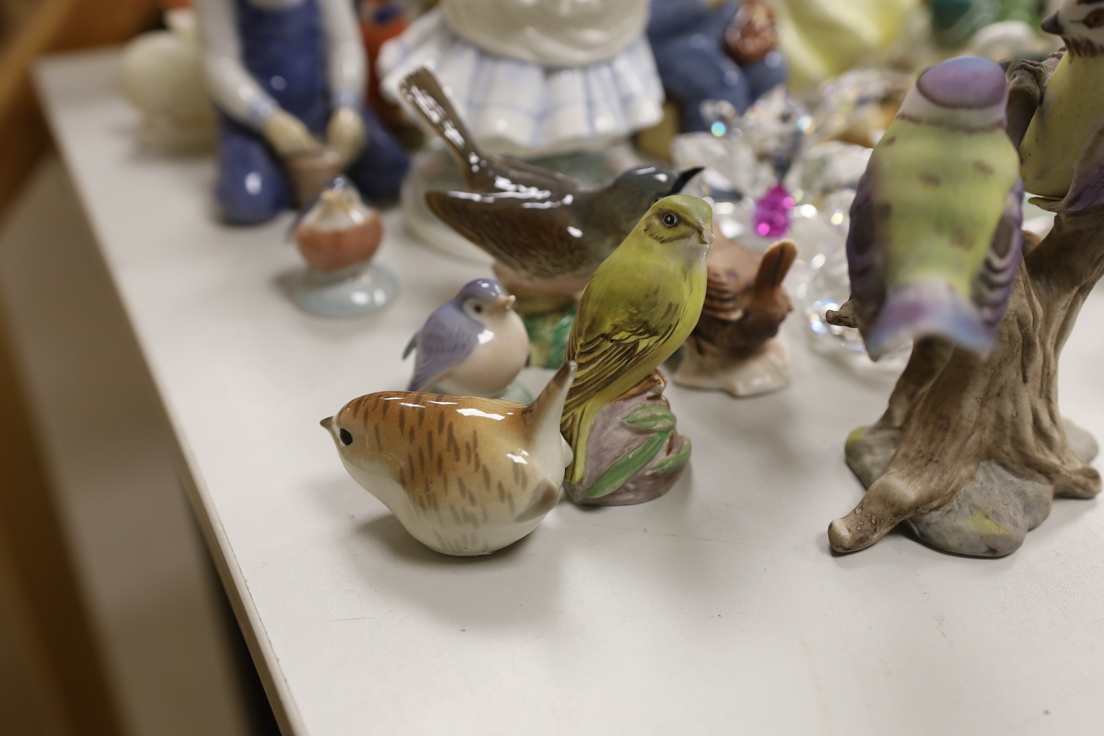 A Royal Copenhagen figure and a collection of Nao ducks, Beswick, Doulton and other birds